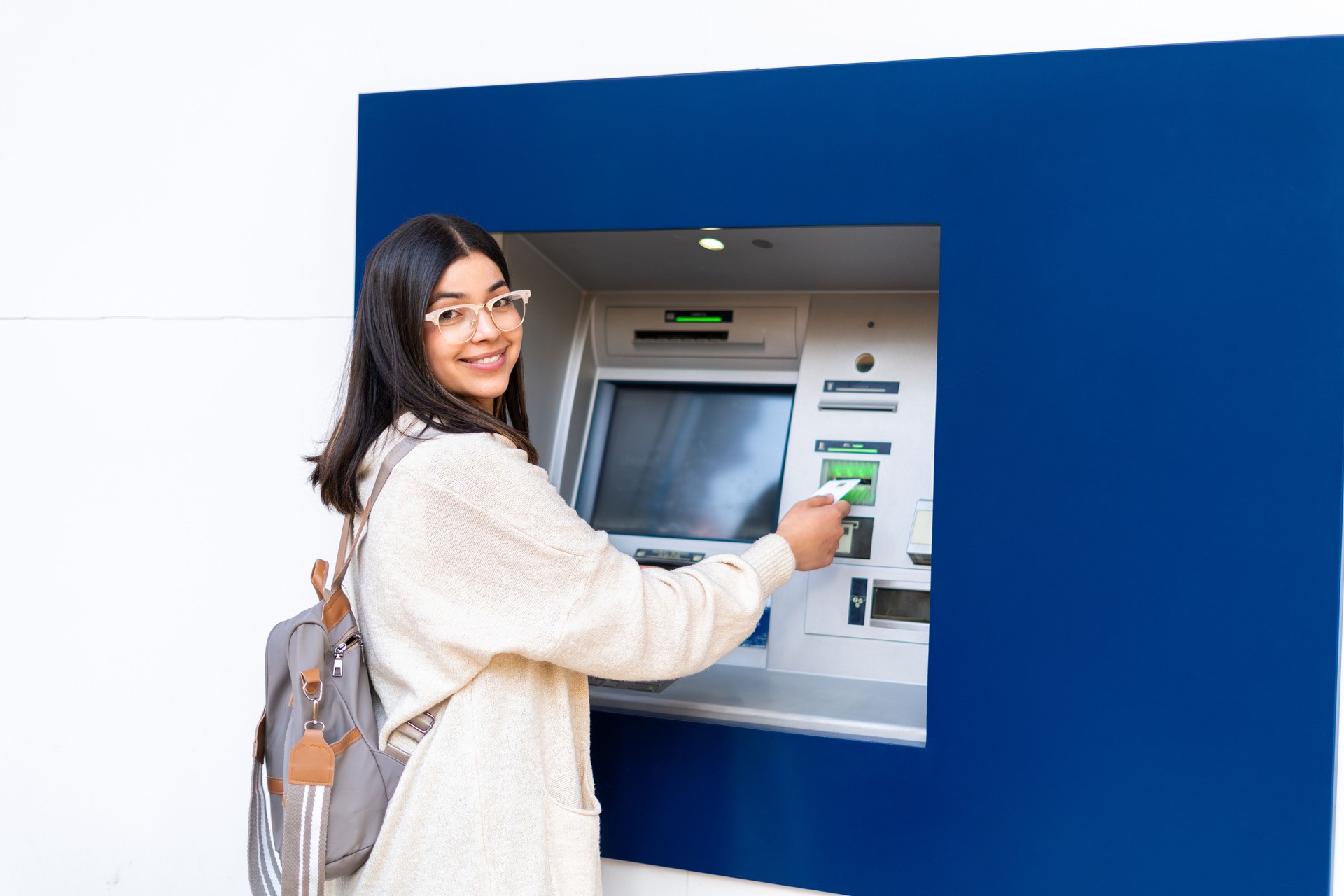 smiling woman, ATM, using ATM, credit card, banking, transaction, finance, technology, cash machine, withdrawal, money, financial services,