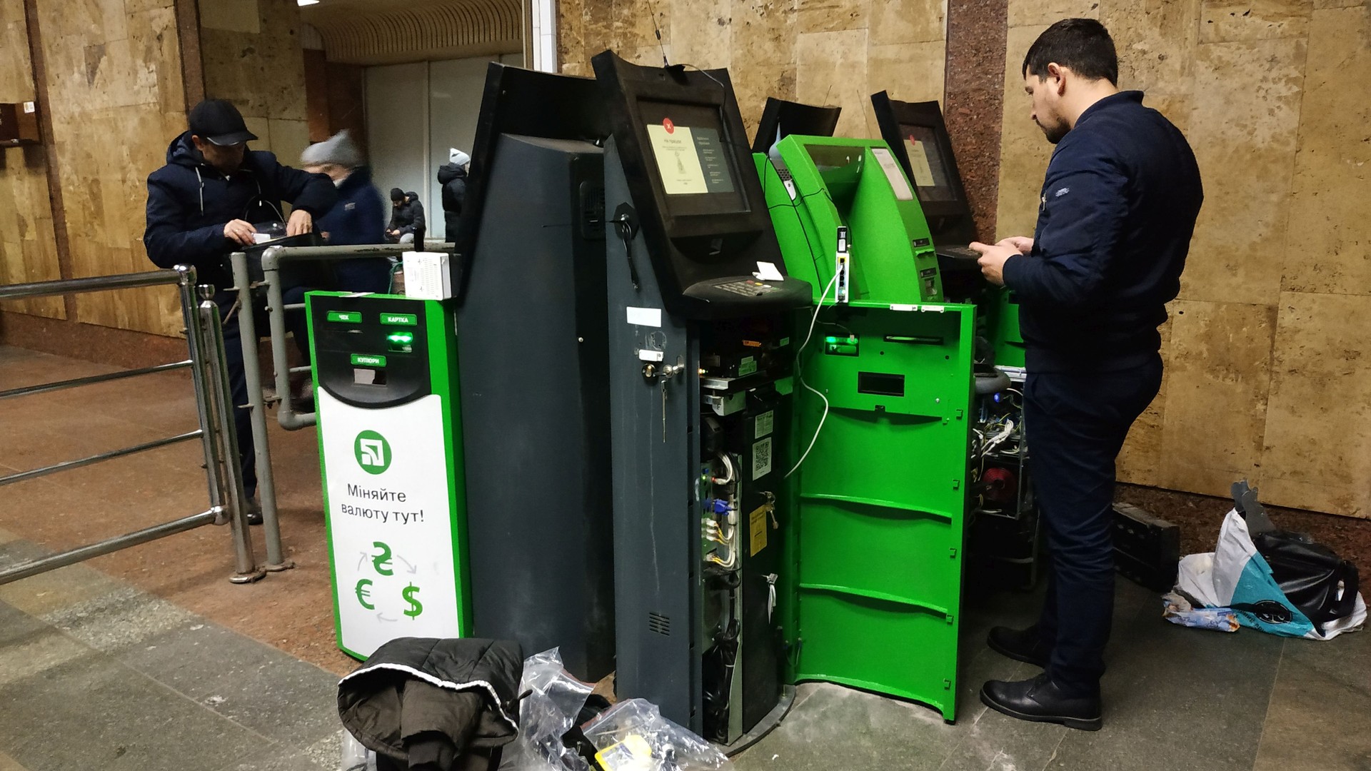 Engineer sets up an ATM and a bank terminal. A bank employee makes an ATM and a terminal review.